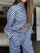 NEWYORKLISTED Comfort Collection: Person wearing a blue and white striped outfit in a room.