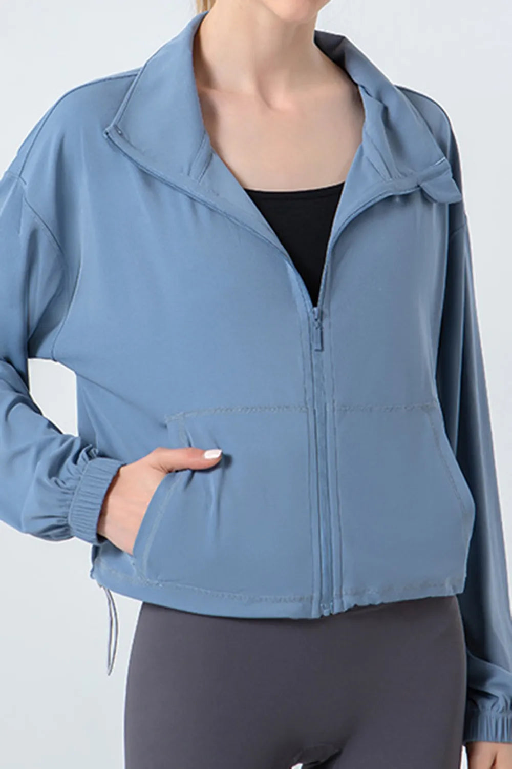 NEWYORKLISTED ACTIVEWEAR COLLECTION: Blue jacket worn by a person on a white background