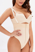 NEWYORKLISTED Intimate Apparel: Woman wearing a beige bodysuit against a white background