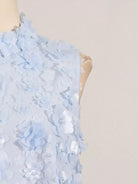 NEWYORKLISTED STYLE COLLECTION: Light blue floral dress on a mannequin against a beige background