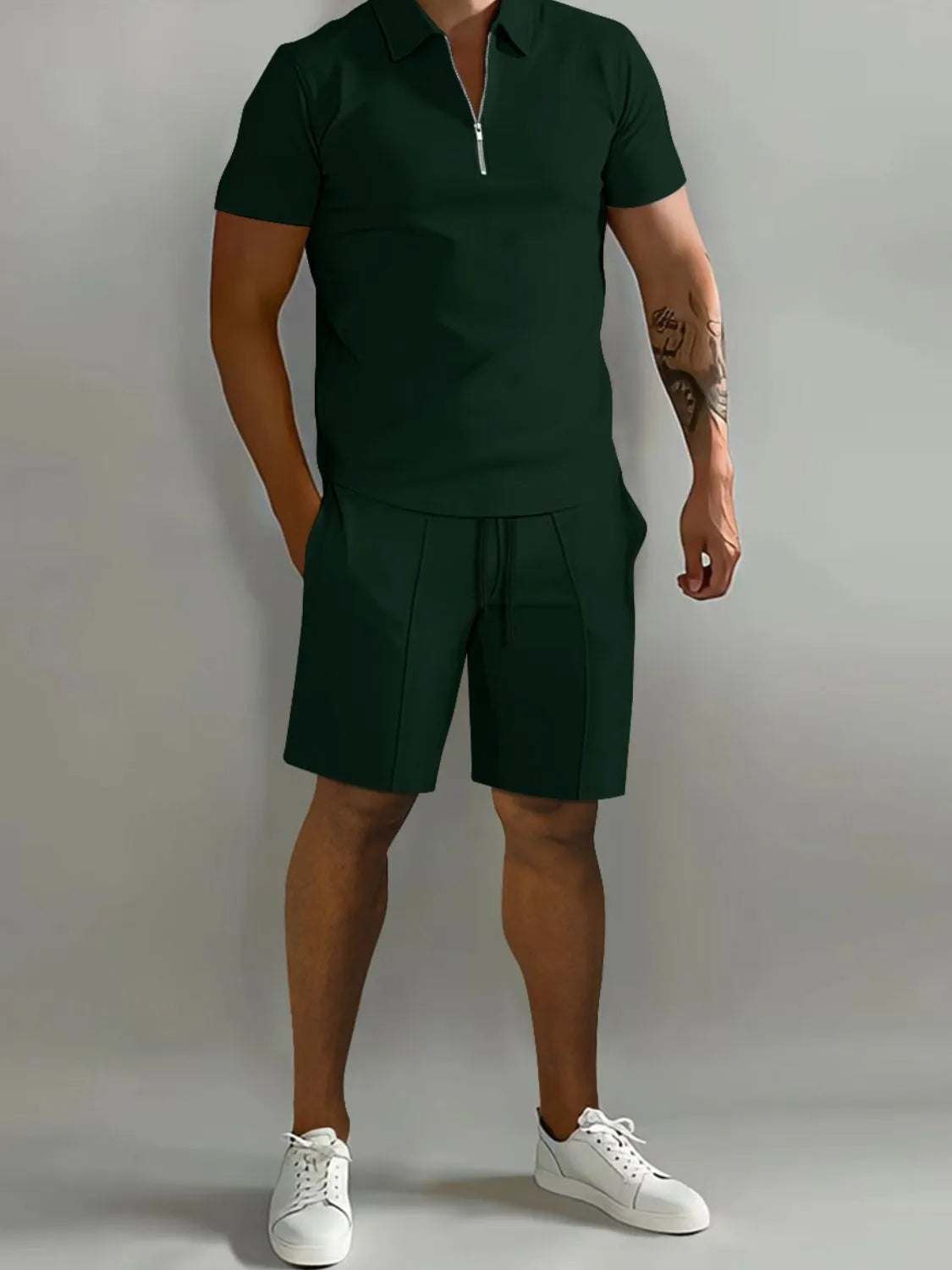 NEWYORKLISTED ATLAS MEN's COLLECTION: Person wearing a green polo shirt and shorts set with white sneakers on a gray background