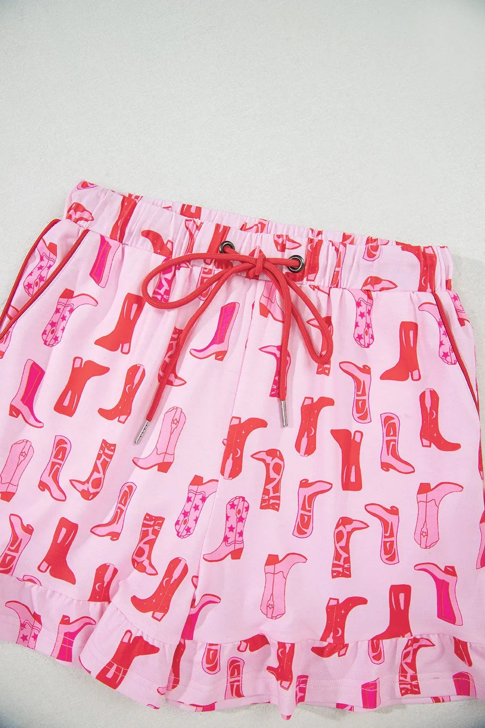 NEWYORKLISTED Intimate Apparel: Skirt with red boot pattern on a light pink background