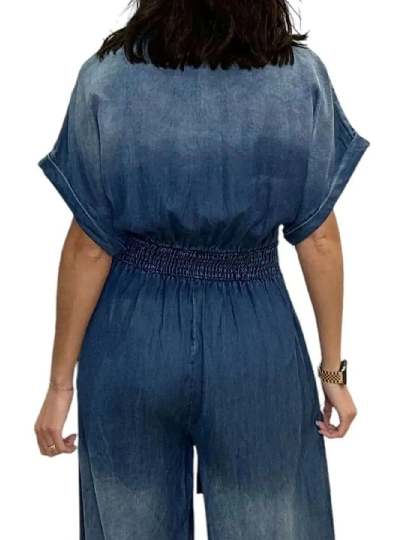 NEWYORKLISTED STYLE COLLECTION: Blue denim jumpsuit worn by a person on a white background