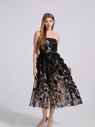 NEWYORKLISTED STYLE COLLECTION: Woman wearing a black floral lace dress on a white background