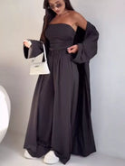 NEWYORKLISTED COMFORT COLLECTION: Woman wearing a long black dress with a white background