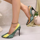 NEWYORKLISTED SHOE COLLECTION: High-heeled shoes with snake print design worn by a person, on a neutral background.
