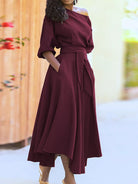 NEWYORKLISTED STYLE COLLECTION: Woman wearing a burgundy dress with a blurred background