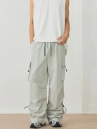 NEWYORKLISTED ATLAS MEN's Collection: Person wearing light gray cargo pants and a white sleeveless top on a plain background