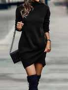 NEWYORKLISTED Style Collection: Person wearing a black sweater dress with blue boots on a blurred street background