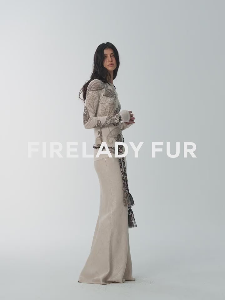 NEWYORKLISTED STYLE COLLECTION: Woman wearing a long fur coat with 'Firelady Fur' branding on a white background
