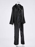 NEWYORKLISTED Intimate Apparel Collection: Black satin pajama set on a mannequin against a white background