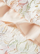 NEWYORKLISTED STYLE COLLECTION: Close-up of beige lace fabric with a subtle pattern