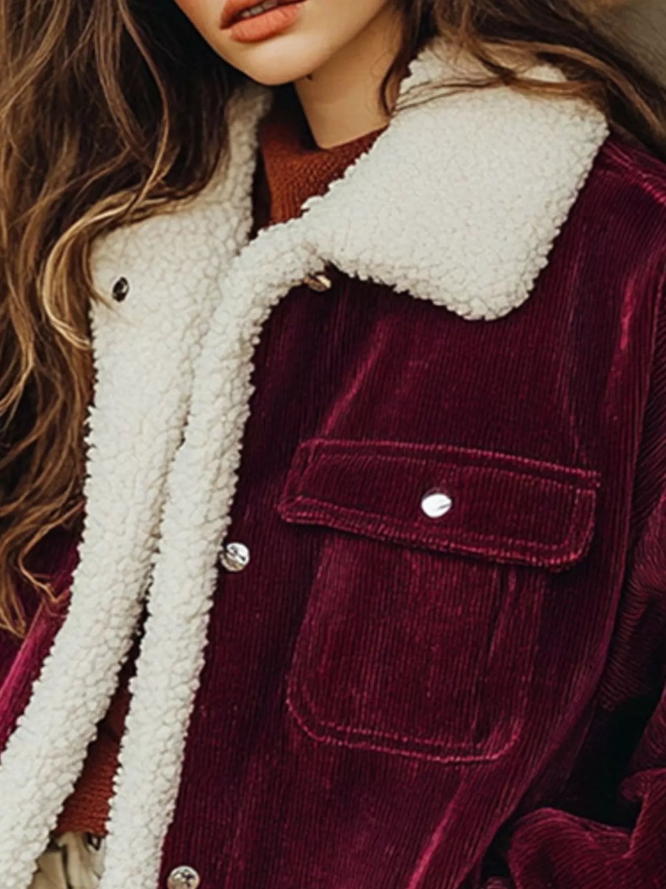 NEWYORKLISTED STYLE COLLECTION: Close-up of a burgundy corduroy jacket with white sherpa lining
