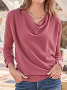 NEWYORKLISTED STYLE COLLECTION: Person wearing a pink long-sleeve top with a blurred background