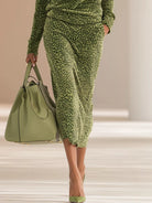 NEWYORKLISTED STYLE COLLECTION: Person wearing a green leopard print outfit holding a matching handbag.