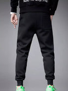 NEWYORKLISTED ATLAS MEN's COLLECTION: Black jogger pants worn by a person on a gray background