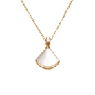 NYLD Glamour By NEWYORKLISTED: Gold necklace with a white pendant on a white background