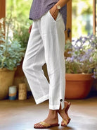 NEWYORKLISTED STYLE COLLECTION: Person wearing white pants with a blurred indoor background
