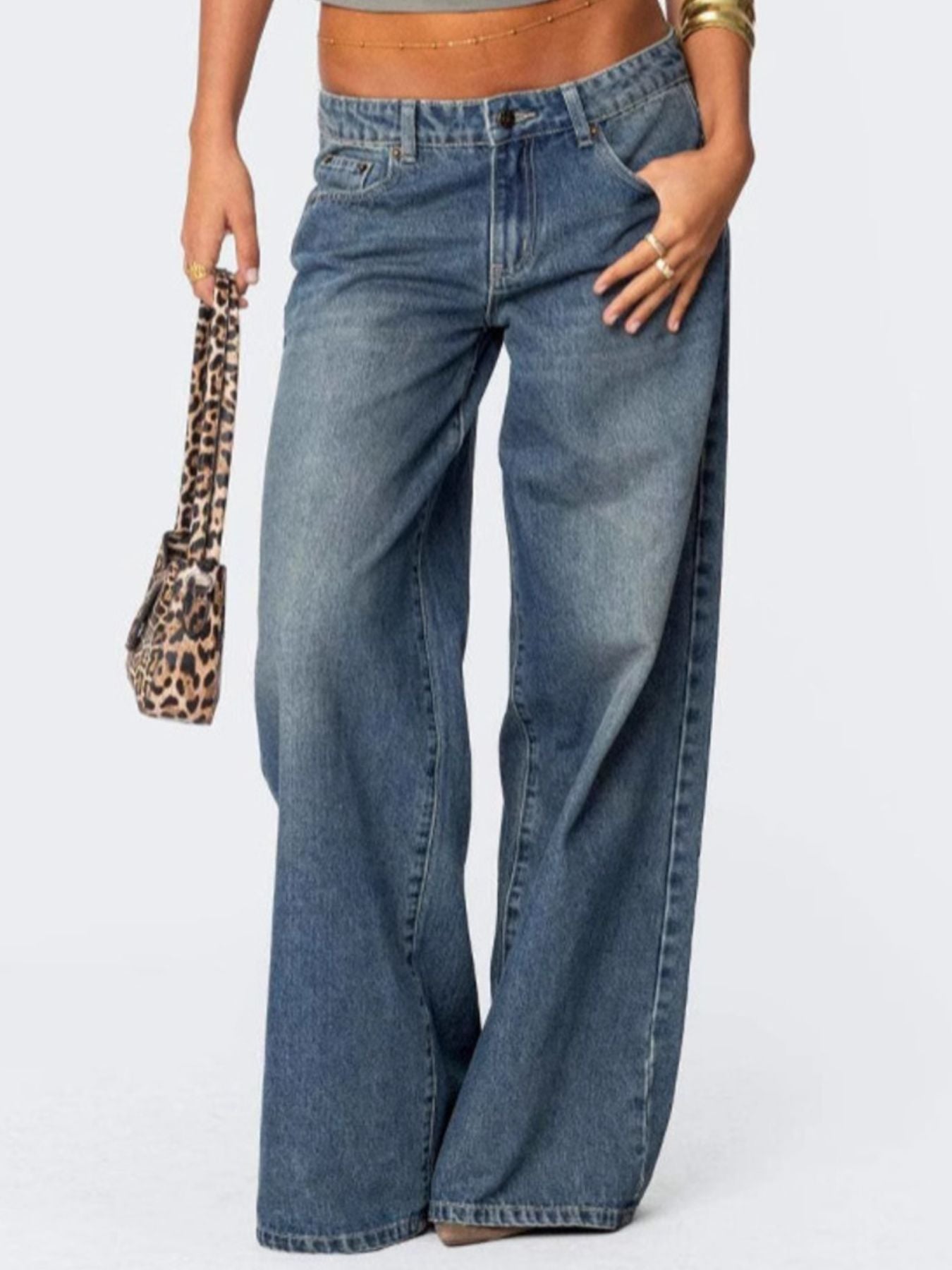 NEWYORKLISTED STYLE COLLECTION: Person wearing blue jeans with a leopard print handbag on a white background