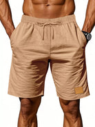 NEWYORKLISTED ATLAS MEN'S COLLECTION: Beige shorts worn by a person on a white background