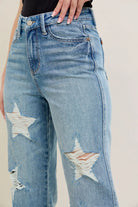 NEWYORKLISTED STYLE COLLECTION: Distressed blue jeans with star designs on a neutral background