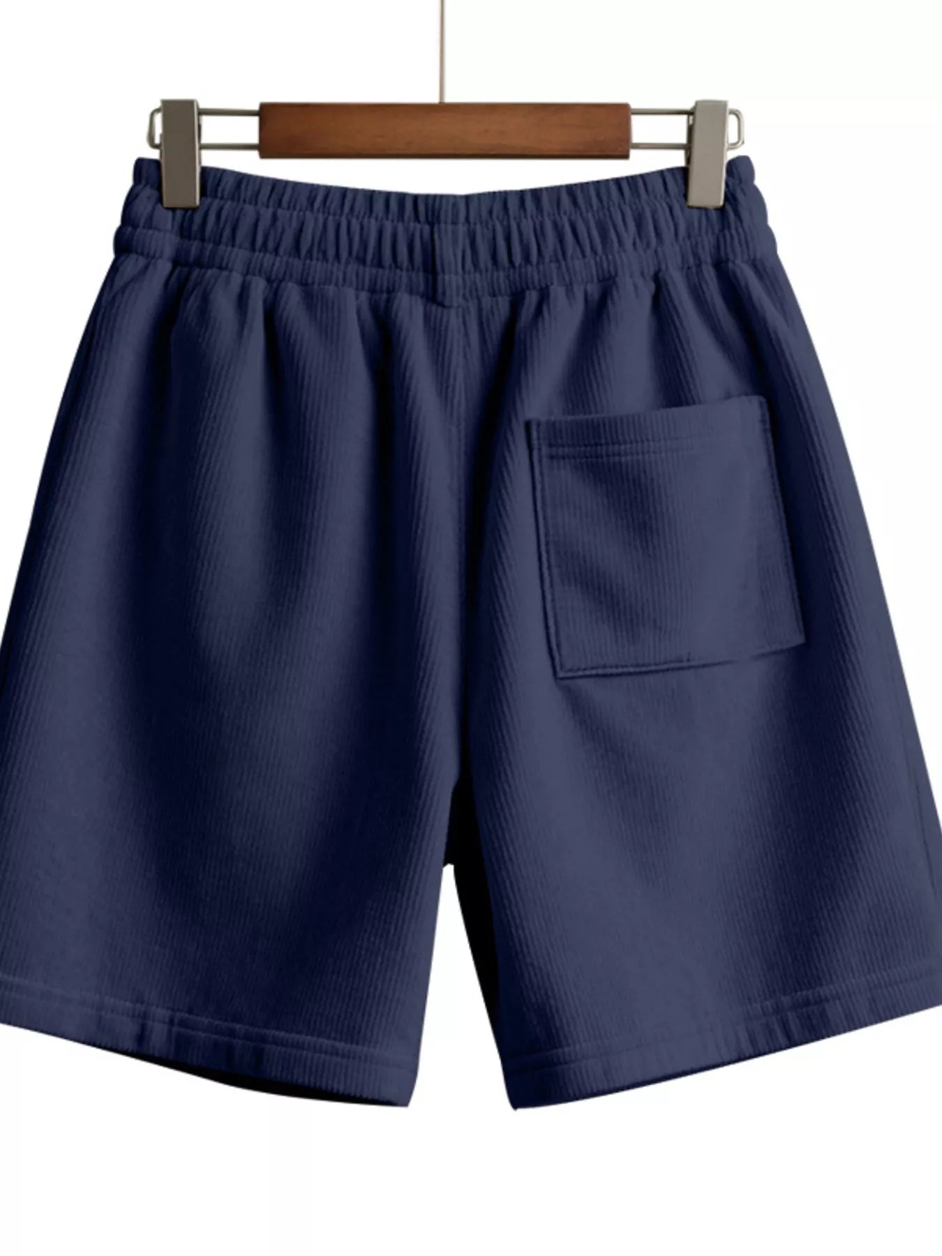 NEWYORKLISTED ATLAS MEN'S COLLECTION: Navy blue shorts on a hanger against a white background
