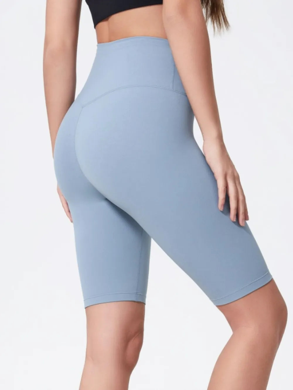 Light blue athletic shorts worn by a person on a white background