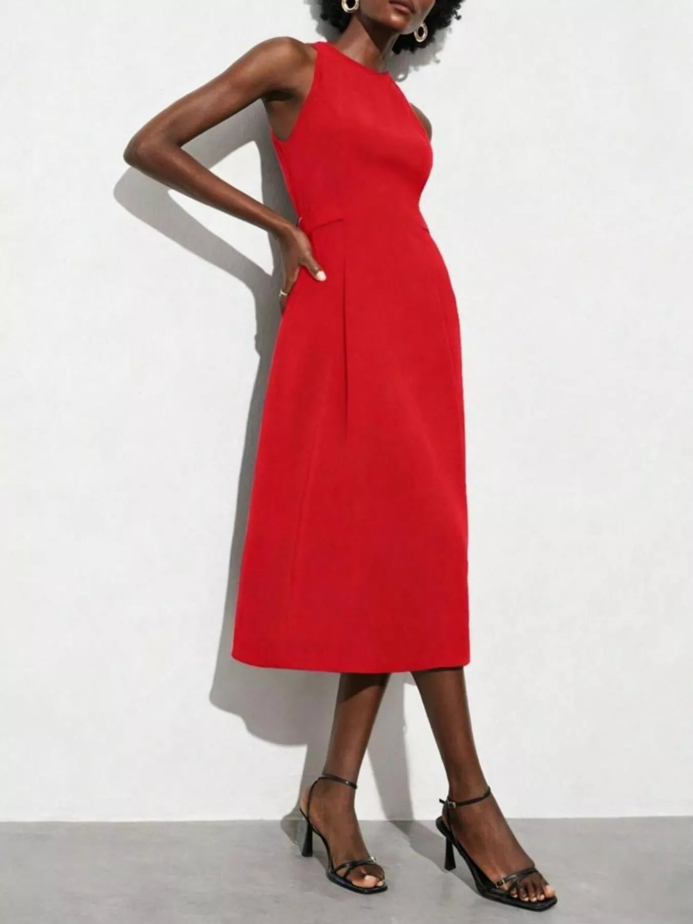 NEWYORKLISTED STYLE COLLECTION: Red dress worn by a model on a white background