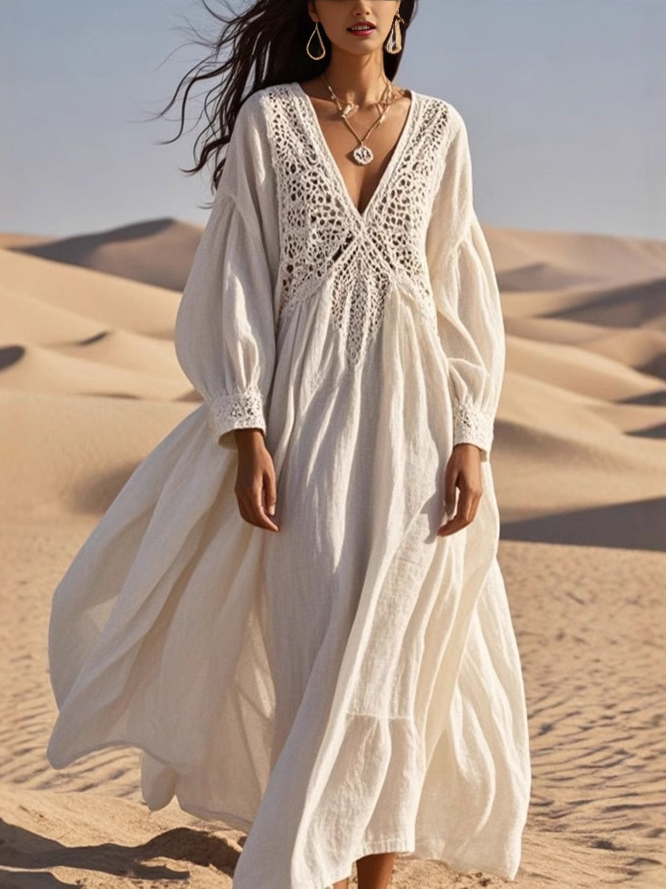 NEWYORKLISTED STYLE COLLECTION: Woman in a white dress with lace details standing in sand dunes