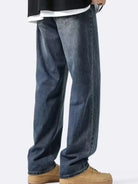 NEWYORKLISTED ATLAS MEN's COLLECTION: Person wearing blue jeans and tan shoes on a white background
