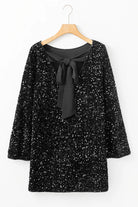 NEWYORKLISTED Valentine's Day Specials: Black sequin dress with a black bow tie on a hanger against a white background
