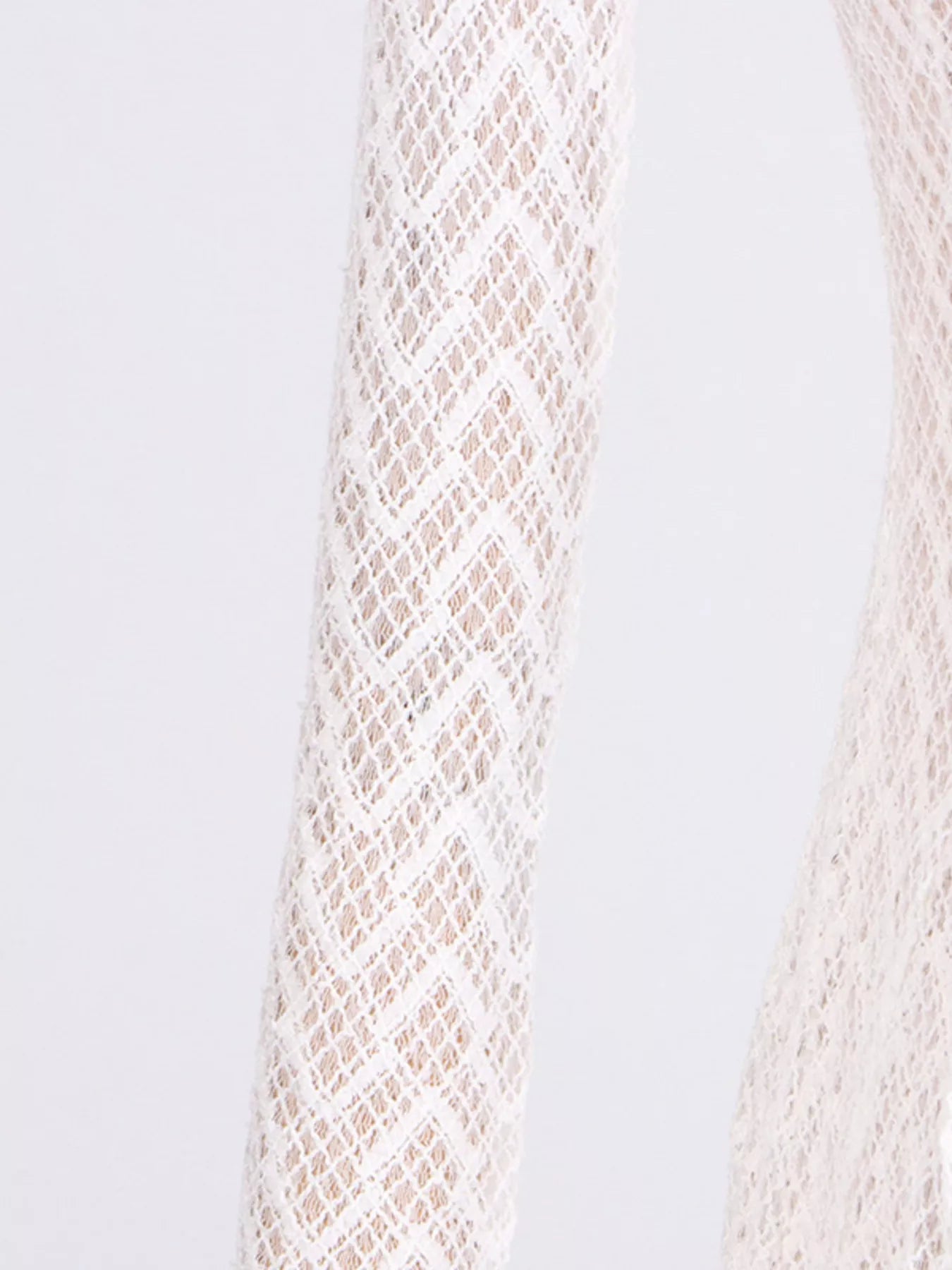 Close-up of a textured beige fabric on a light gray background
