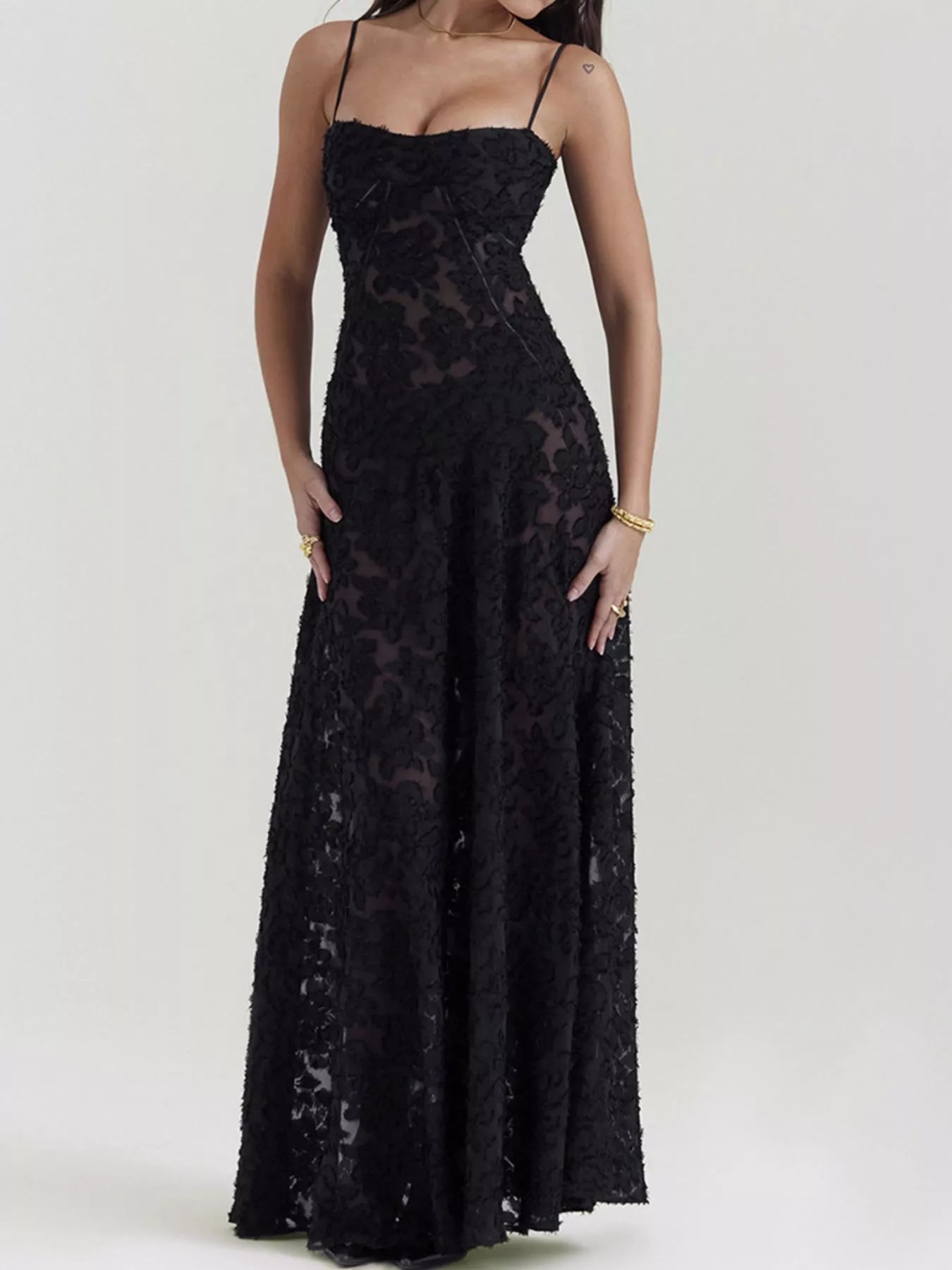NEWYORKLISTED STYLE COLLECTION: Black lace dress worn by a model on a white background