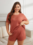 NEWYORKLISTED Intimate Apparel Collection: Woman wearing a terracotta-colored lounge set in a living room.