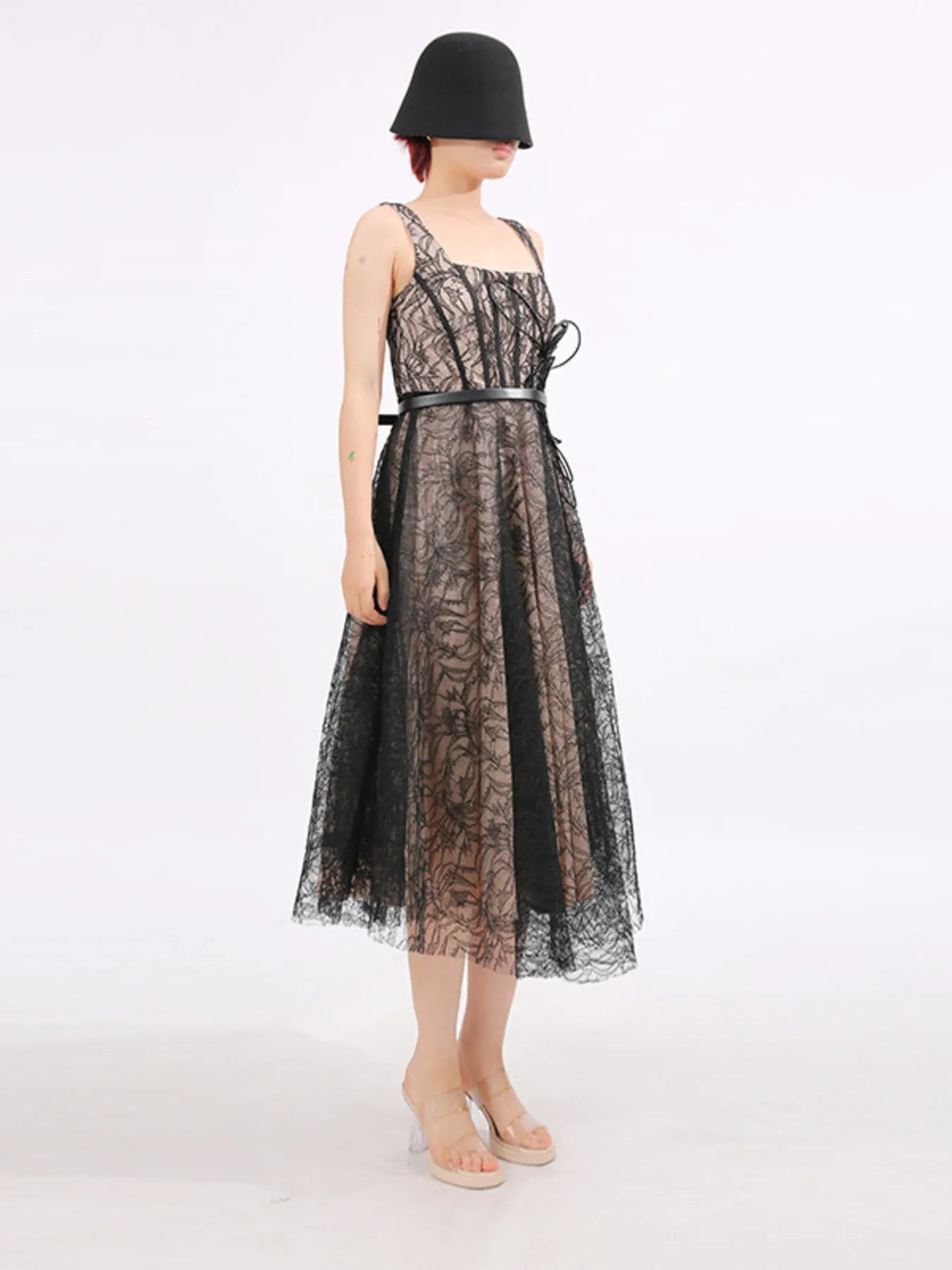 NEWYORKLISTED RUNWAY STYLE: Black lace dress worn by a person on a white background