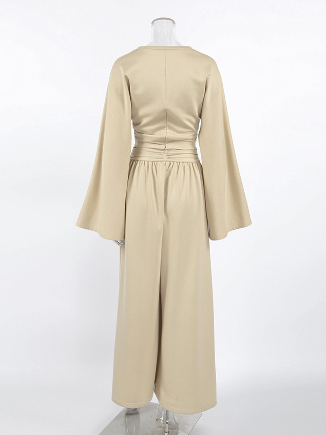 NEWYORKLISTED STYLE COLLECTION: Beige dress with long sleeves on a mannequin against a white background