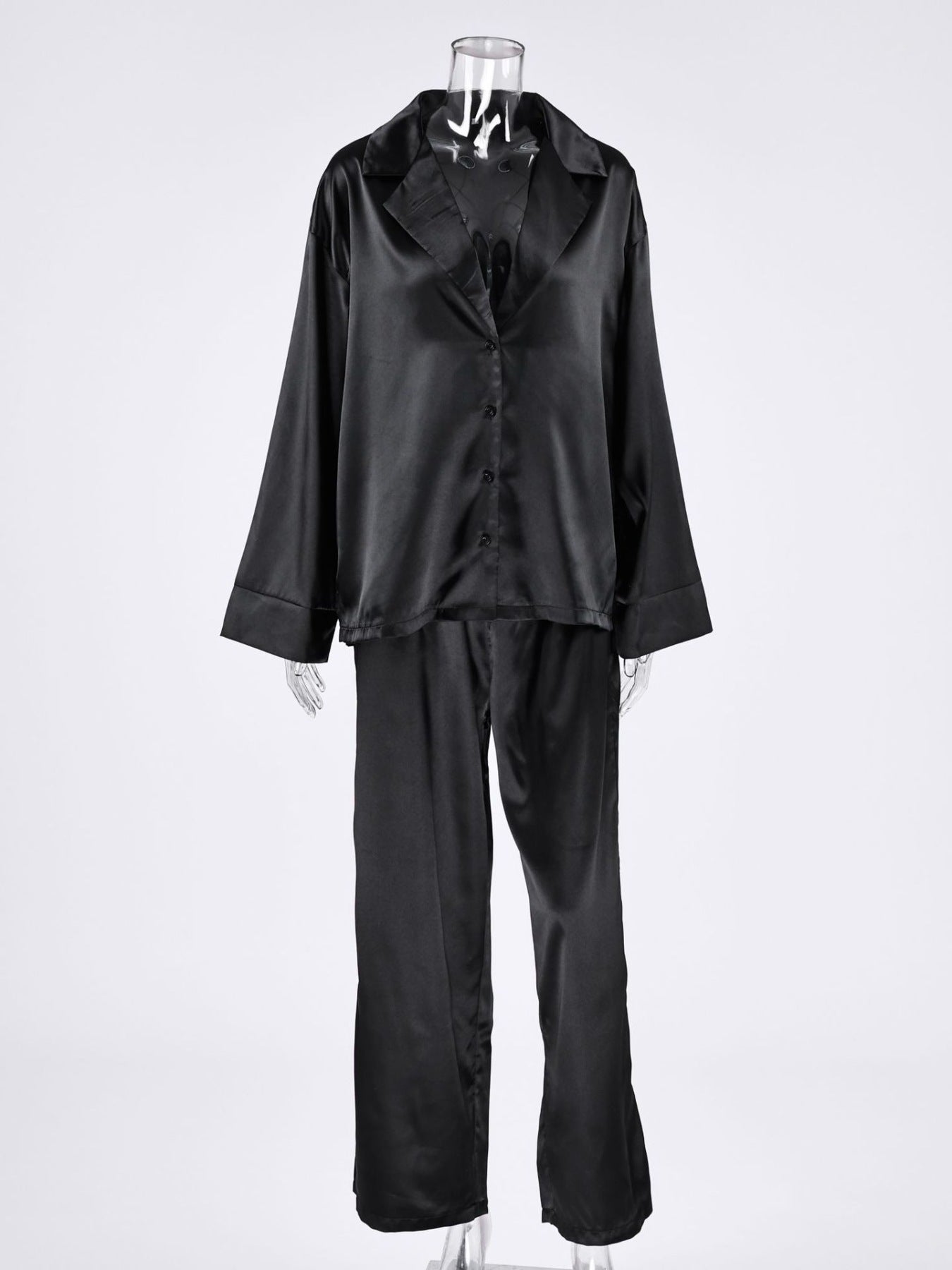 NEWYORKLISTED Intimate Apparel Collection: Black satin pajama set on a mannequin against a white background