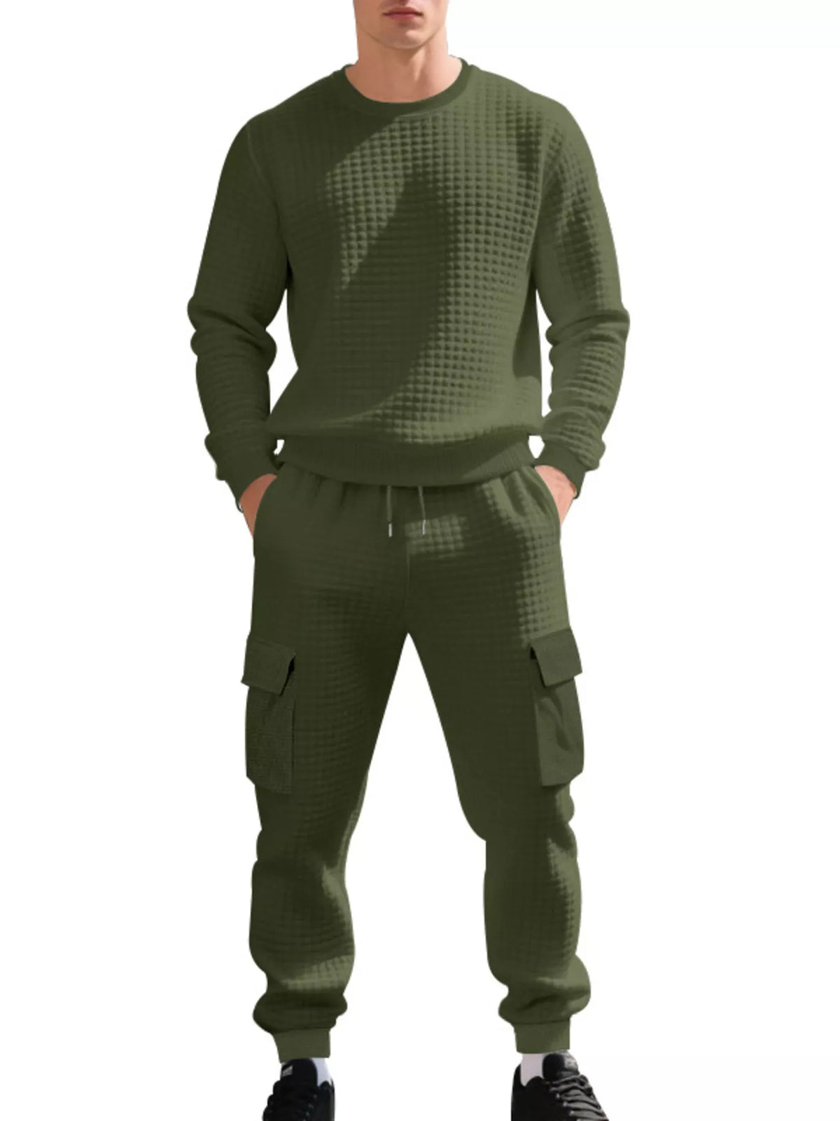 NEWYORKLISTED ATLAS MEN'S COLLECTION: A man wearing a matching olive green waffle-knit sweatshirt and jogger pants set with cargo pockets, shown against a plain white background.