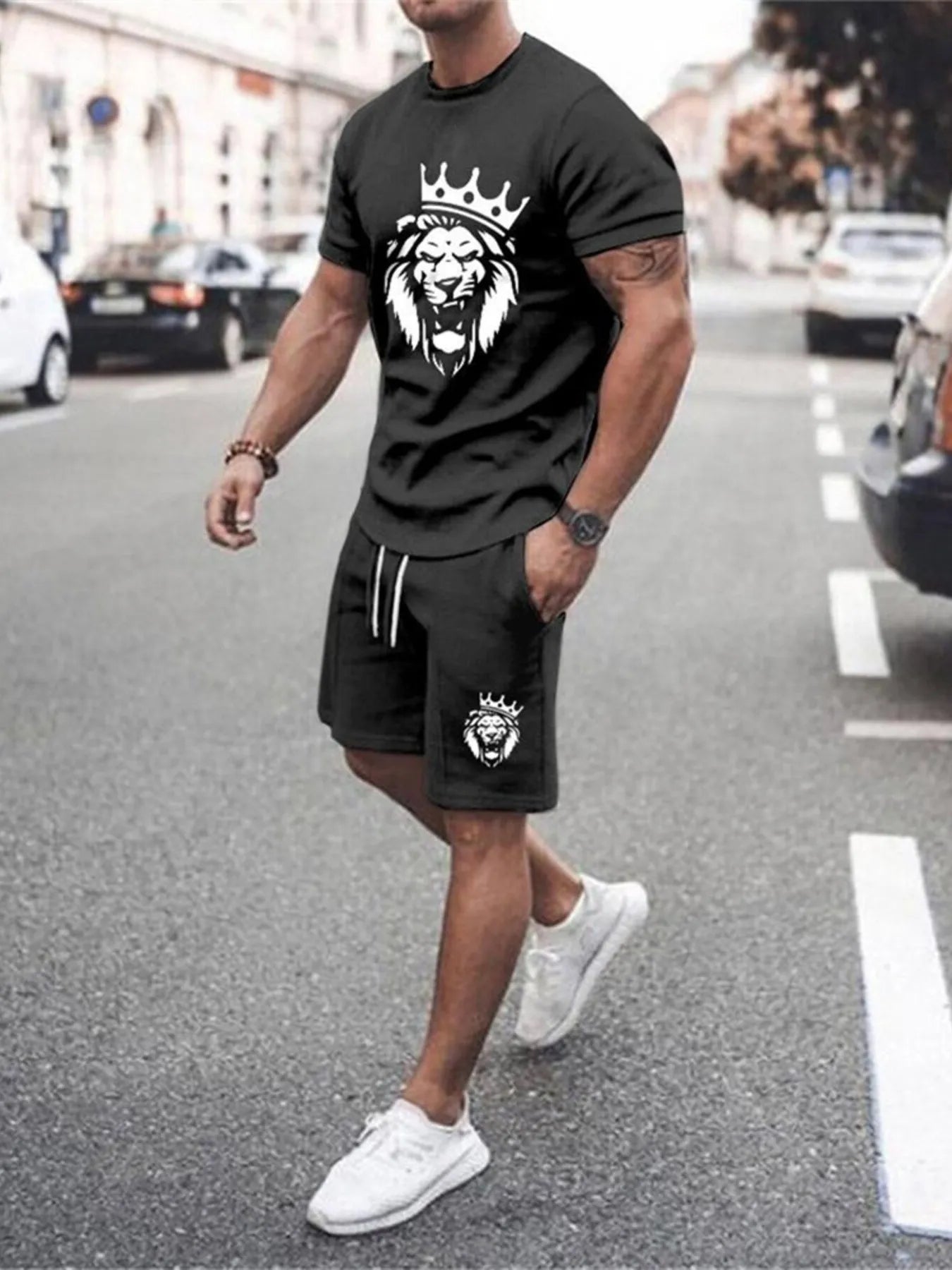 NEWYORKLISTED ATLAS MEN's COLLECTION: Man wearing a black t-shirt and shorts with a lion graphic on a street.