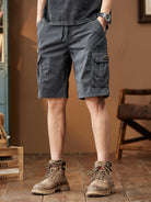 NEWYORKLISTED ATLAS MEN's COLLECTION: Person wearing dark gray cargo shorts with a brown background