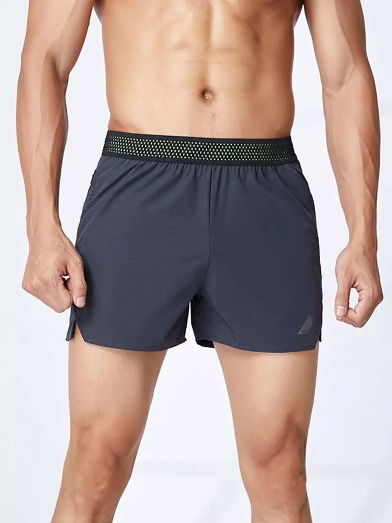 NEWYORKLISTED ATLAS MEN's COLLECTION: Man wearing dark gray athletic shorts with a white background