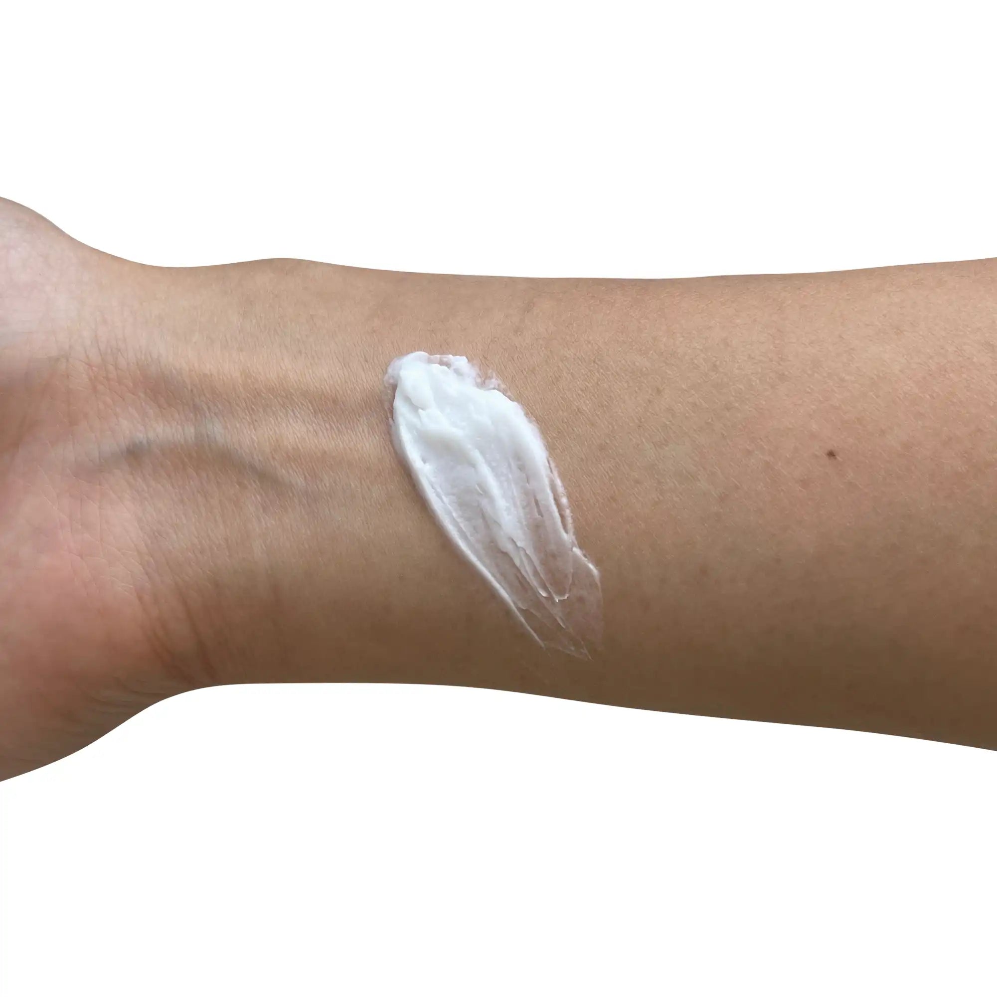 NEWYORKLISTED COSMETIC COLLECTION: White cream applied to a person's arm on a white -background