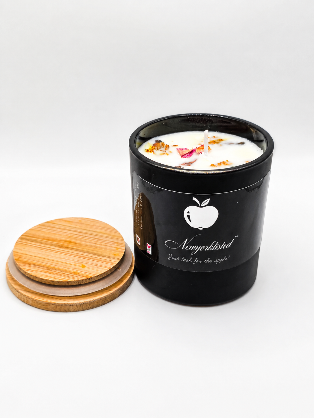 NEWYORKLISTED LUXURY SENSORY COLLECTION™: Botanical Wood Wick Candle – Hand-Poured Luxury Spa Candle: Black candle container with a white candle inside, wooden lid, and 'Newfoundland' branding on a white background.