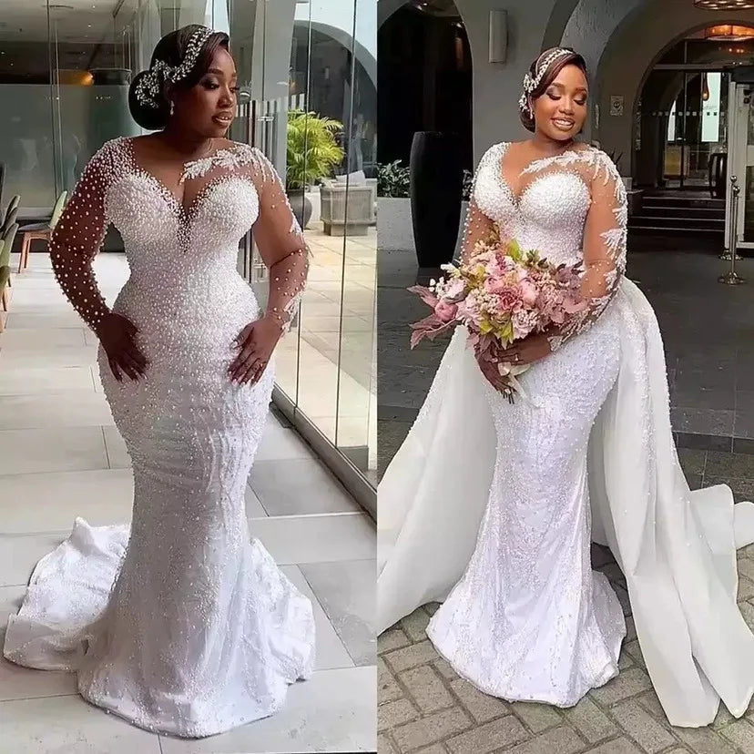 Plus-size mermaid wedding dress with pearl embellishments, illusion sleeves, sweetheart neckline, and detachable train, NEWYORKLISTED ELEGANT BRIDE COLLECTION.