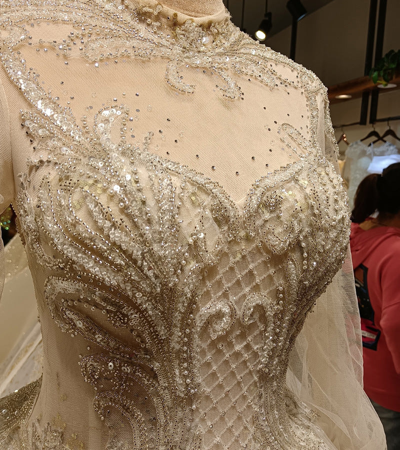 Close-up of a beaded and embroidered dress on a mannequin with a blurred background