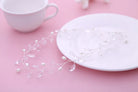 White ceramic plate with decorative elements on a pink surface