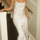 NEWYORKLISTED: Woman in a white satin dress standing on a staircase