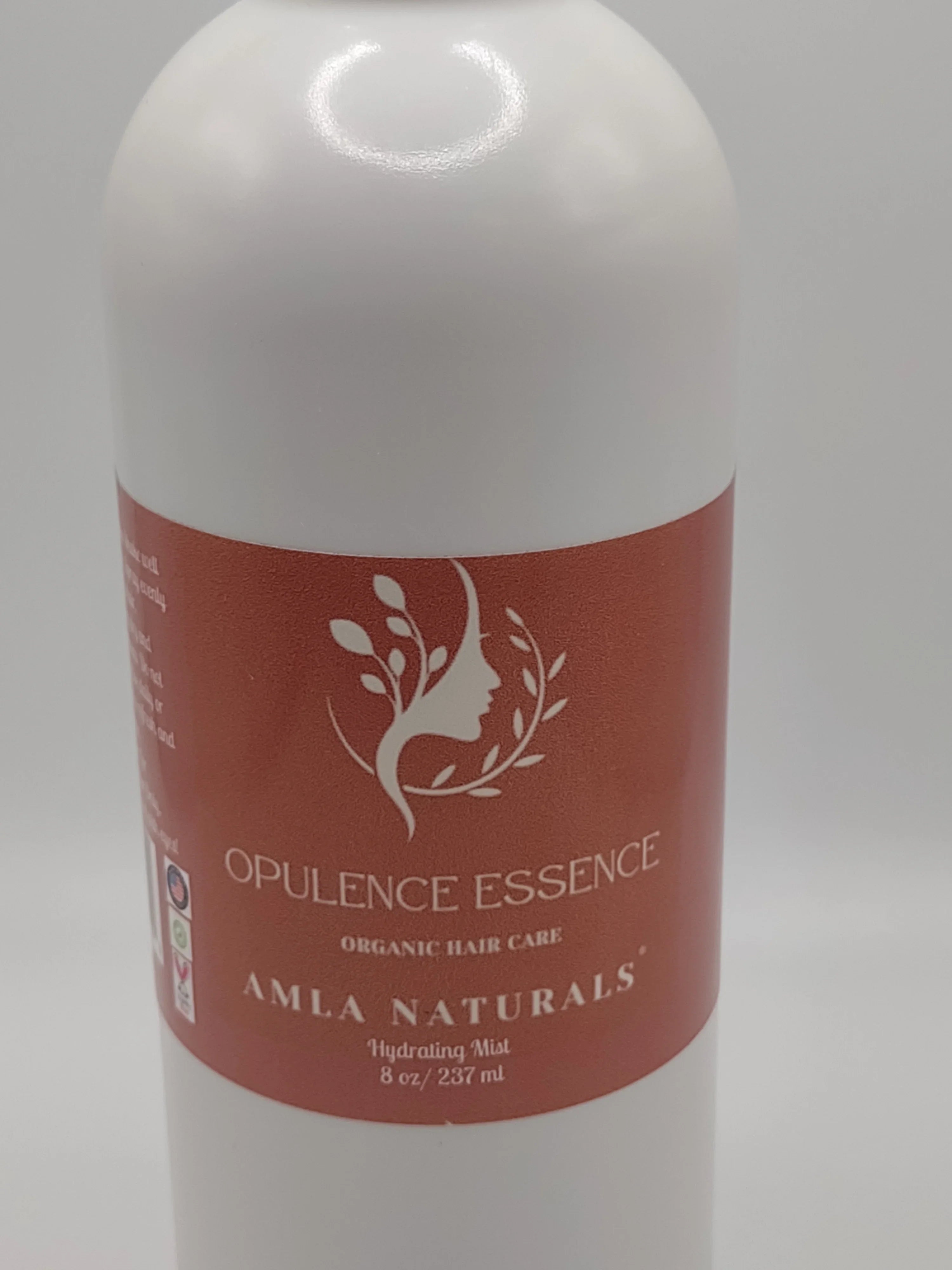 Opulence Essence bottle with red label on a white background: NEWYORKLSITED.COM