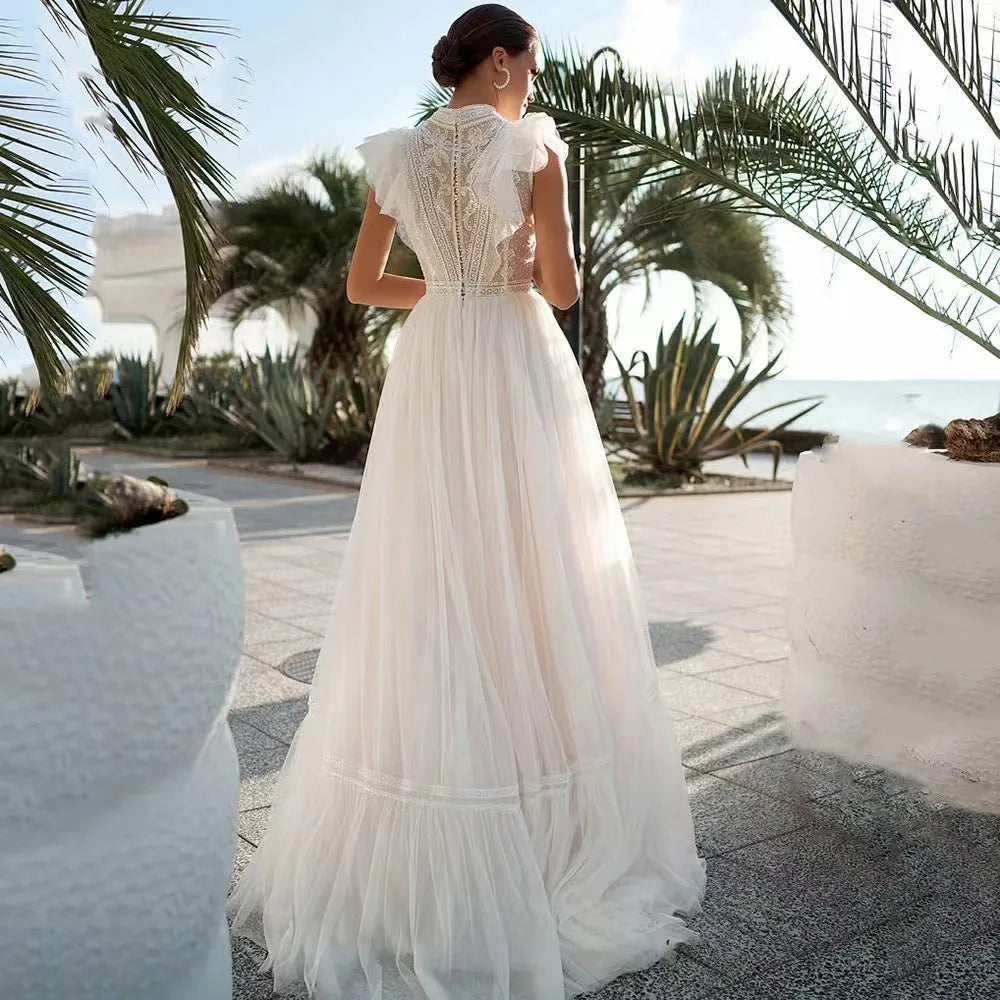 Woman in a white dress standing in a tropical setting with palm trees and a clear sky.
