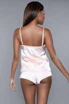 NEWYORKLISTED Intimate Apparel Collection: Woman wearing a white satin nightgown against a gray background
